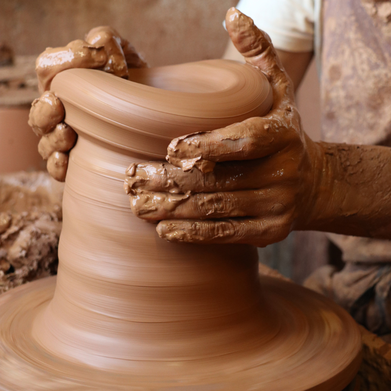 Artisan potier tournant un pot en terre cuite à la main dans les ateliers des Poteries d’Albi